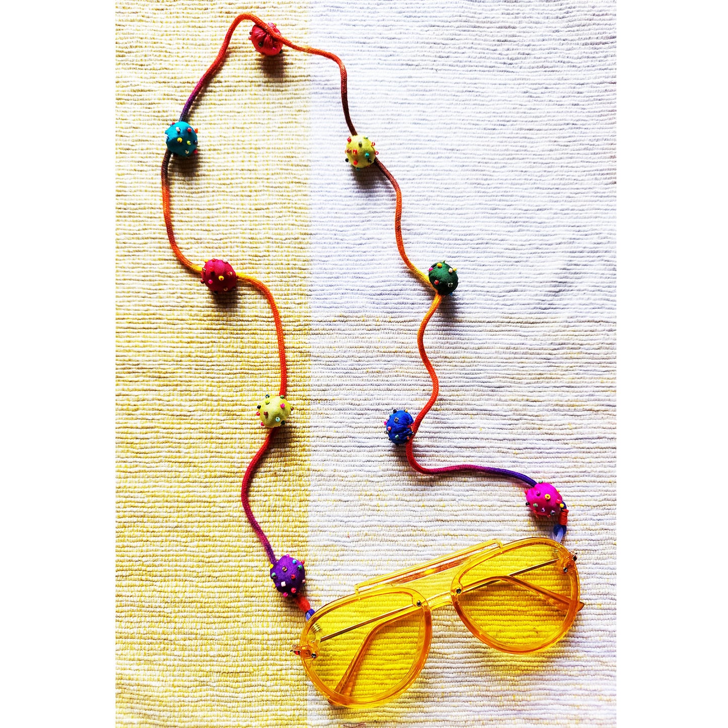 Silk beaded bauble spectacle string